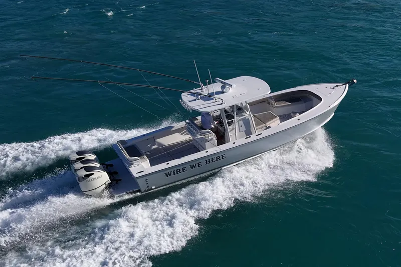 Slide: The Image of 2021 Albury Brothers 33 boat cruising on open water with triple Suzuki engines. - 0