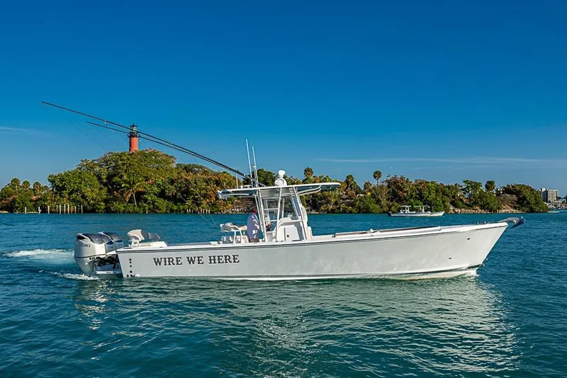 Slide: The Image of 2021 Albury Brothers 33 boat cruising on blue water near lush island. - 1