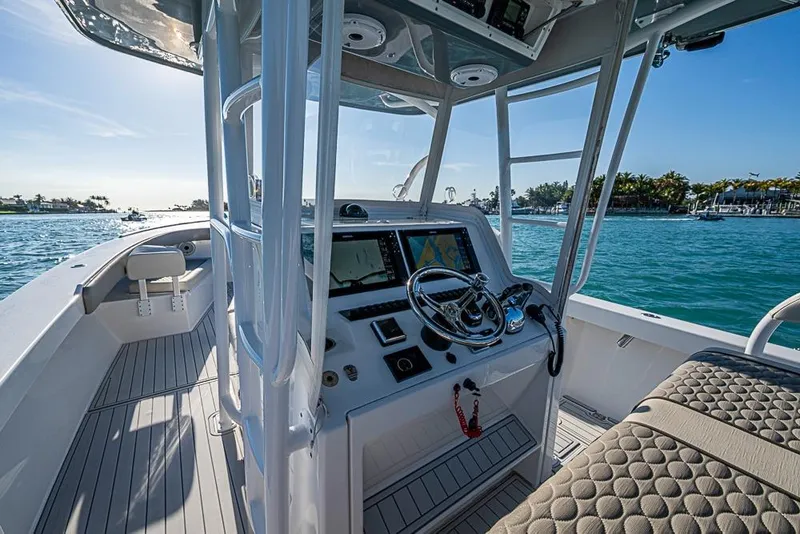 Slide: The Image of 2021 Albury Brothers 33 boat interior with steering console and navigation screens. - 12