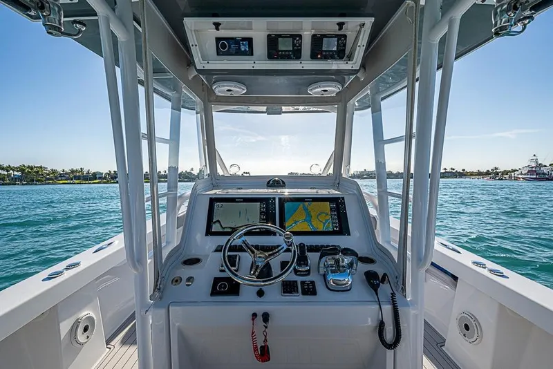 Slide: The Image of 2021 Albury Brothers 33 boat helm with navigation screens and controls on open water. - 13
