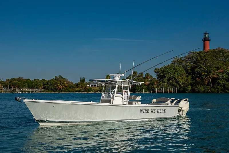Slide: The Image of 2021 Albury Brothers 33 boat on water near lighthouse and trees. - 2