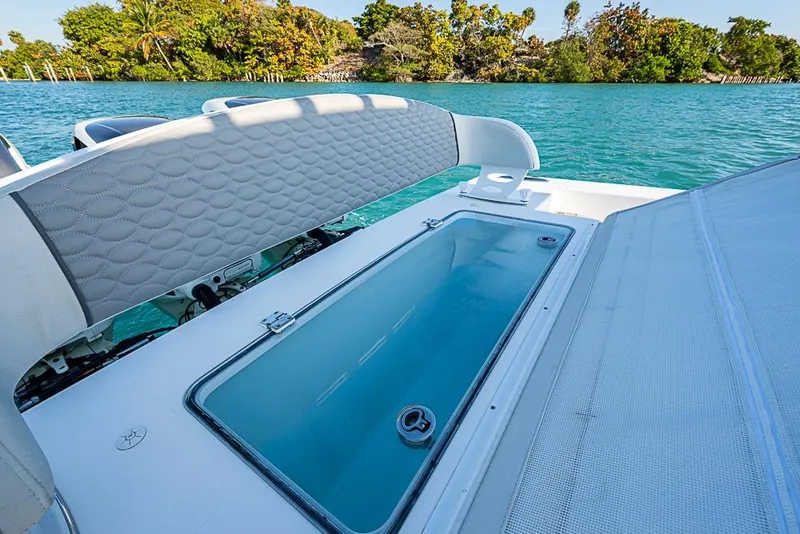 Slide: The Image of 2021 Albury Brothers 33 boat with open storage compartment on turquoise water. - 20