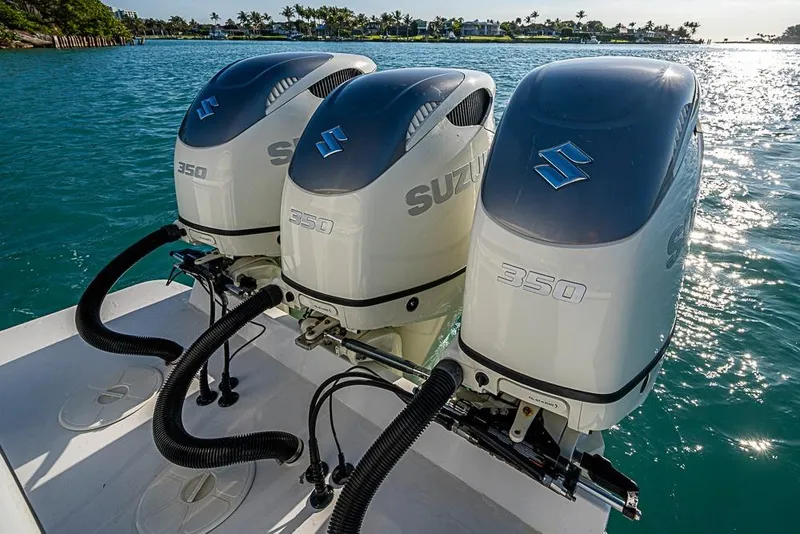 Slide: The Image of Triple Suzuki 350 outboard engines on a 2021 Albury Brothers 33 boat in sunny waters. - 22