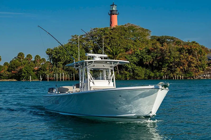 Slide: The Image of 2021 Albury Brothers 33 boat cruising near a lighthouse, surrounded by lush greenery. - 23