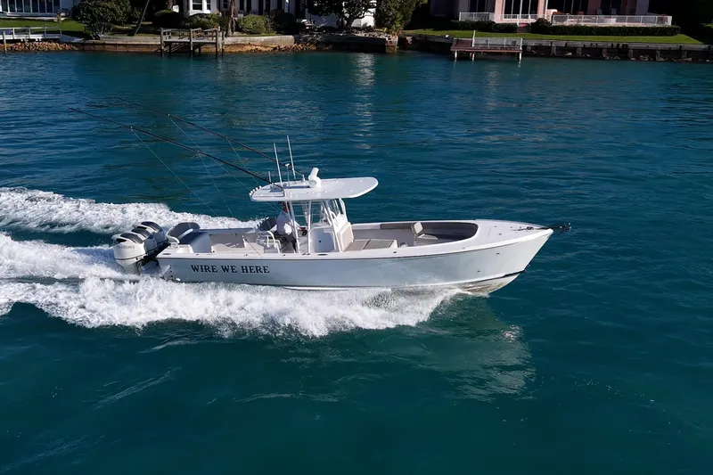 Slide: The Image of 2021 Albury Brothers 33 boat cruising on clear blue water. - 27