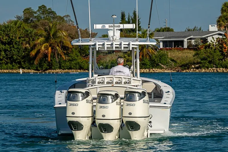 Slide: The Image of 2021 Albury Brothers 33 boat with triple Suzuki 350 engines on a scenic waterway. - 4