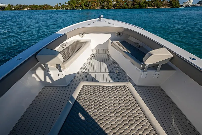 Slide: The Image of 2021 Albury Brothers 33 boat interior with cushioned seating and sleek design on the water. - 5