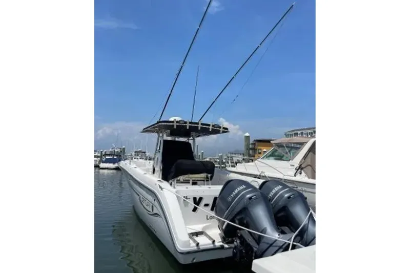 Slide: The Image of 2004 Century 3200 Center Console boat docked with dual Yamaha engines. - 1