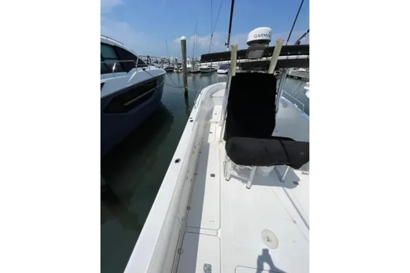Slide: The Image of 2004 Century 3200 Center Console boat docked at marina, featuring Garmin equipment. - 10