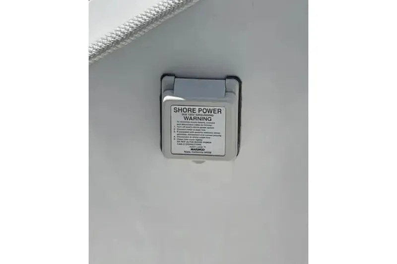 Slide: The Image of Shore power warning label on 2004 Century 3200 Center Console boat. - 20
