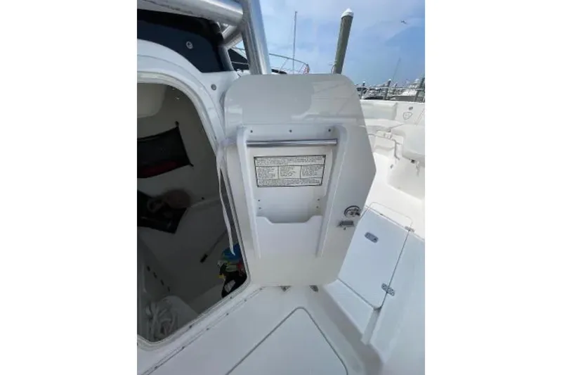 Slide: The Image of 2004 Century 3200 Center Console boat interior with open storage compartment. - 26