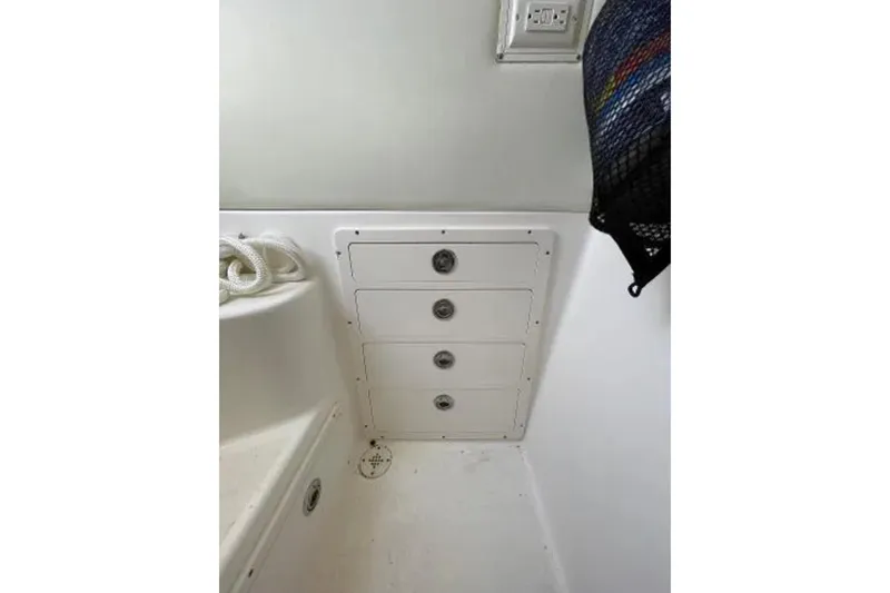 Slide: The Image of Storage compartment on a 2004 Century 3200 Center Console boat interior. - 28