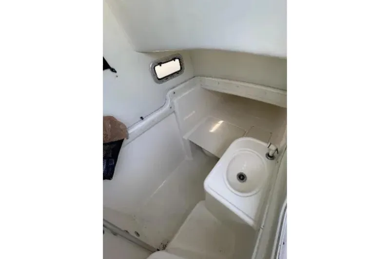 Slide: The Image of Interior of a 2004 Century 3200 Center Console boat with sink and window. - 31
