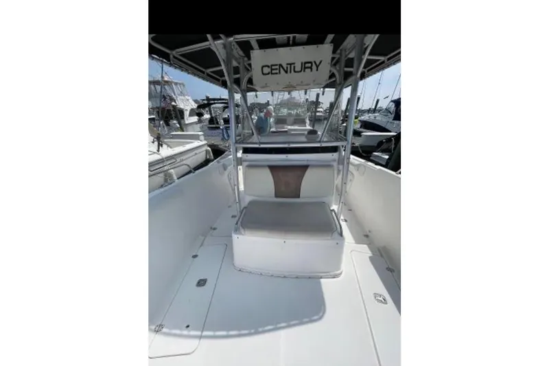 Slide: The Image of 2004 Century 3200 Center Console boat interior with seating and console view. - 34