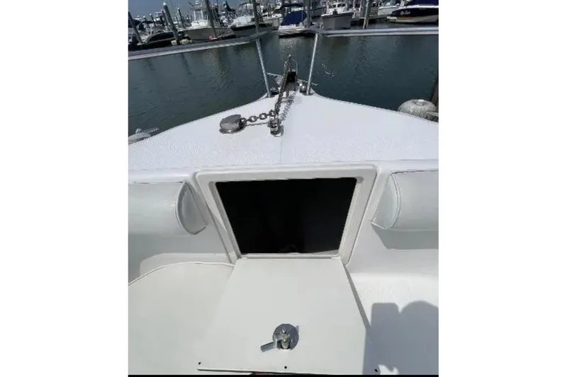 Slide: The Image of 2004 Century 3200 Center Console boat bow with anchor chain, docked at marina. - 38