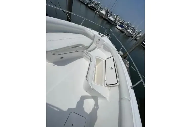 Slide: The Image of 2004 Century 3200 Center Console boat interior with open storage compartment, docked at marina. - 40
