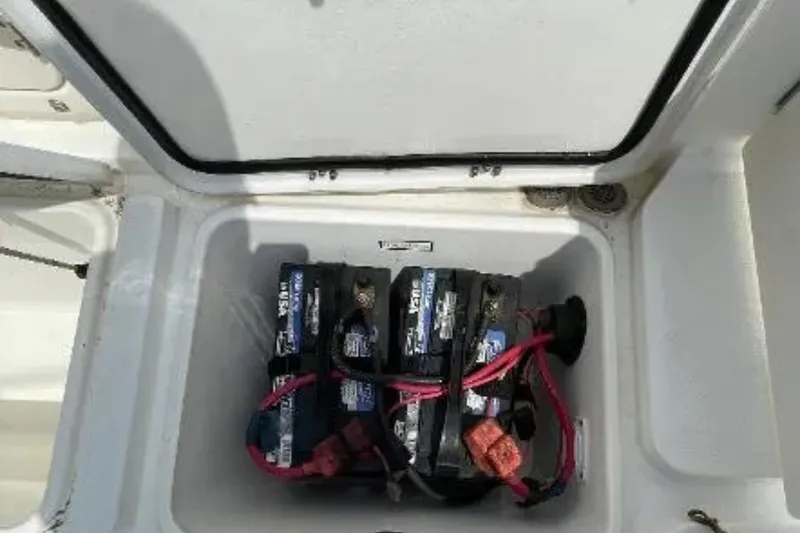 Slide: The Image of Battery compartment of a 2004 Century 3200 Center Console boat with visible wiring. - 42