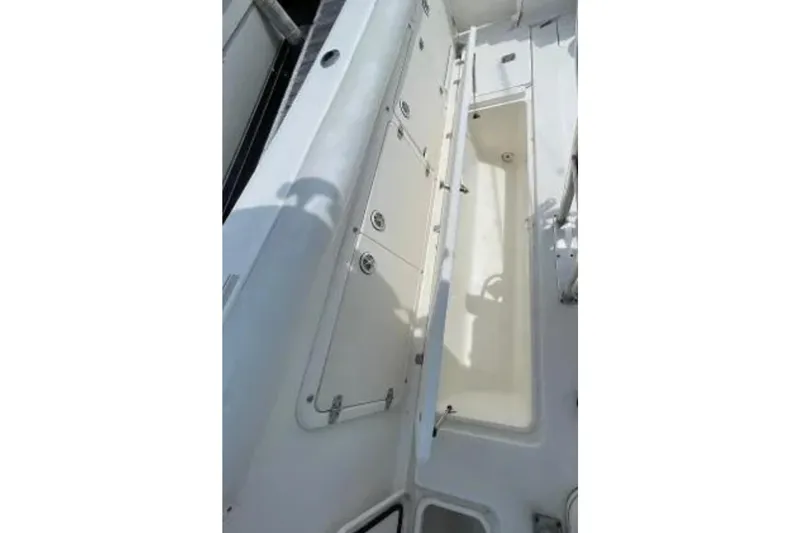 Slide: The Image of 2004 Century 3200 Center Console boat interior with open storage compartments. - 46