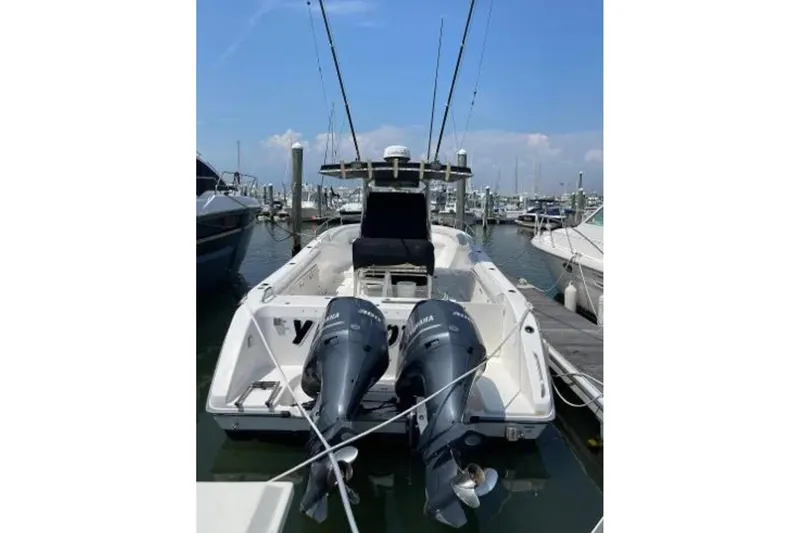 Slide: The Image of 2004 Century 3200 Center Console boat docked with twin Yamaha outboard engines. - 7