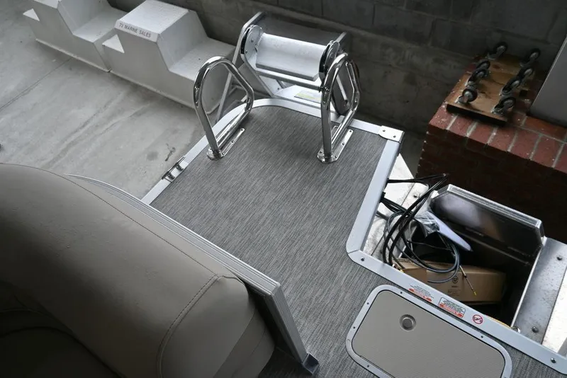Slide: The Image of 2026 Bennington S Quad Bench 22 SSR boat deck with ladder and storage compartment. - 7