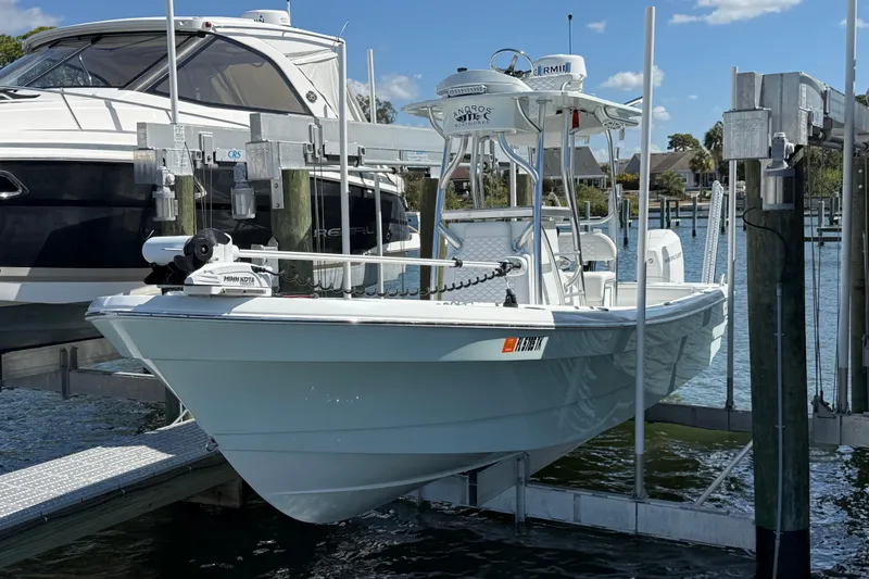 Slide: The Image of 2023 Andros Tarpon 26 boat on a lift at the marina. - 10