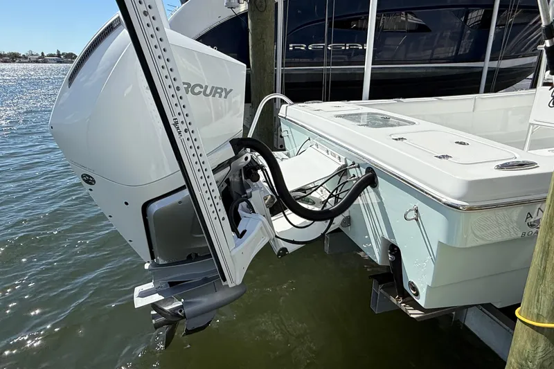 Slide: The Image of 2023 Andros Tarpon 26 boat with Mercury engine docked by the water. - 13