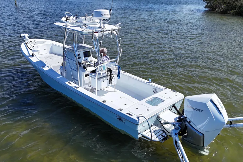 Slide: The Image of 2023 Andros Tarpon 26 boat on calm water. - 2