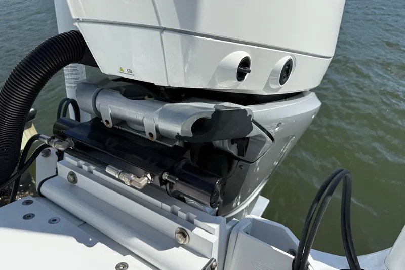 Slide: The Image of Close-up of a 2023 Andros Tarpon 26 boat motor by the water. - 20