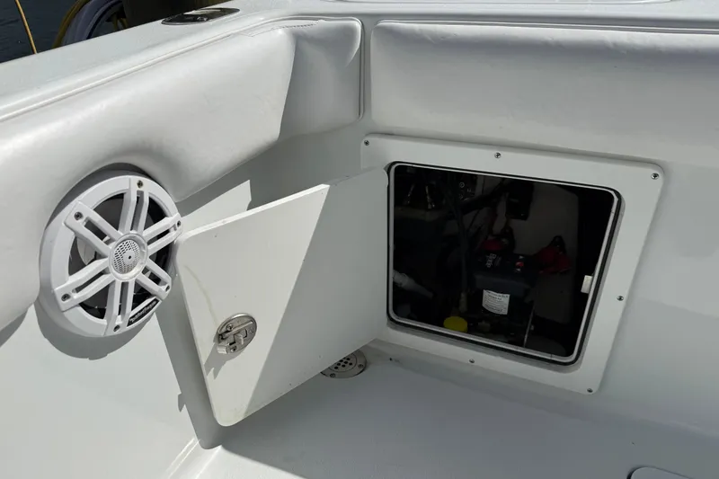Slide: The Image of 2023 Andros Tarpon 26 boat with speaker and open storage compartment. - 25