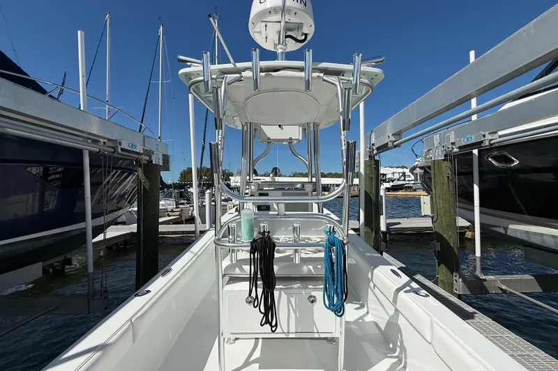 Slide: The Image of 2023 Andros Tarpon 26 boat docked, clear blue sky. - 31