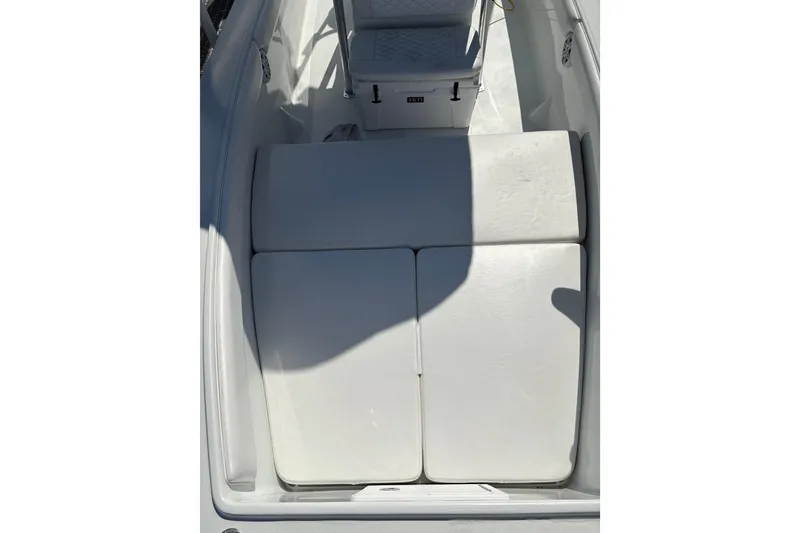 Slide: The Image of 2023 Andros Tarpon 26 boat interior with cushioned seating and storage area. - 61