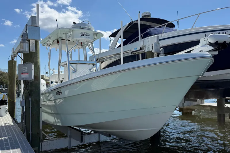 Slide: The Image of 2023 Andros Tarpon 26 boat on a lift at the dock. - 8