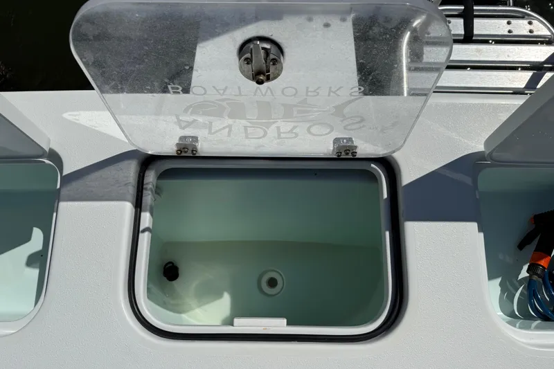 Slide: The Image of 2023 Andros Tarpon 26 boat with open storage compartment lid. - 24