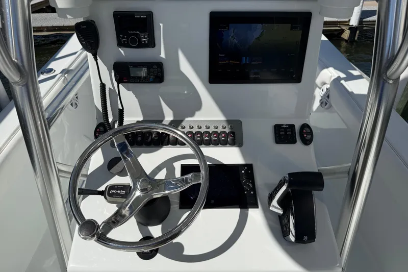 Slide: The Image of 2023 Andros Tarpon 26 boat dashboard with steering wheel and controls. - 46