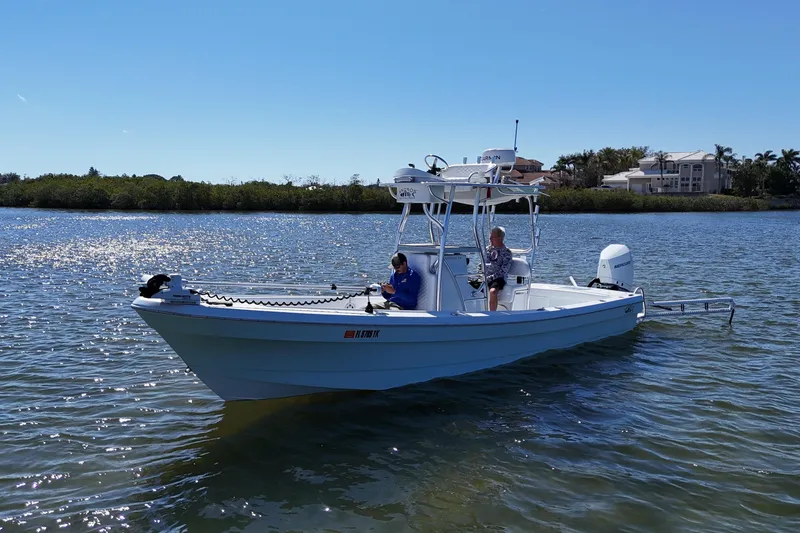 Slide: The Image of 2023 Andros Tarpon 26 boat on calm water. - 6