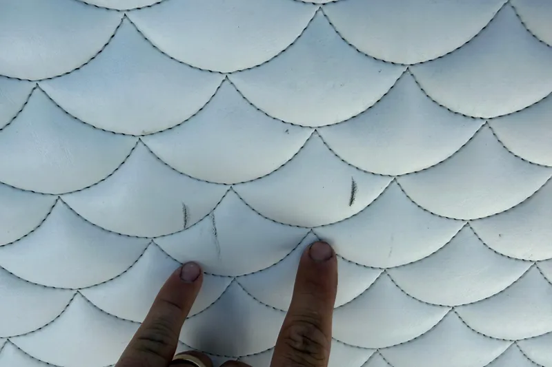Slide: The Image of Two fingers pointing at textured white upholstery on 2023 Andros Tarpon 26 boat. - 84