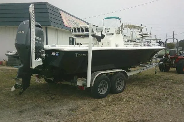 Slide: The Image of 2021 Tidewater 2110 Bay Max boat on trailer with Yamaha engine, parked outdoors. - 1