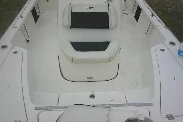 Slide: The Image of 2021 Tidewater 2110 Bay Max boat interior with white seating and spacious layout. - 14