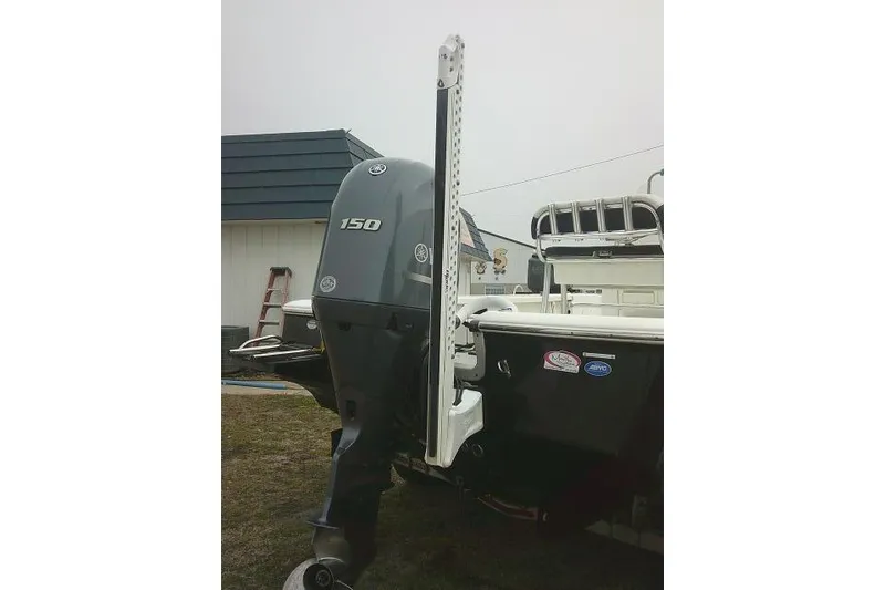 Slide: The Image of 2021 Tidewater 2110 Bay Max boat with 150 HP outboard motor, docked outdoors. - 5