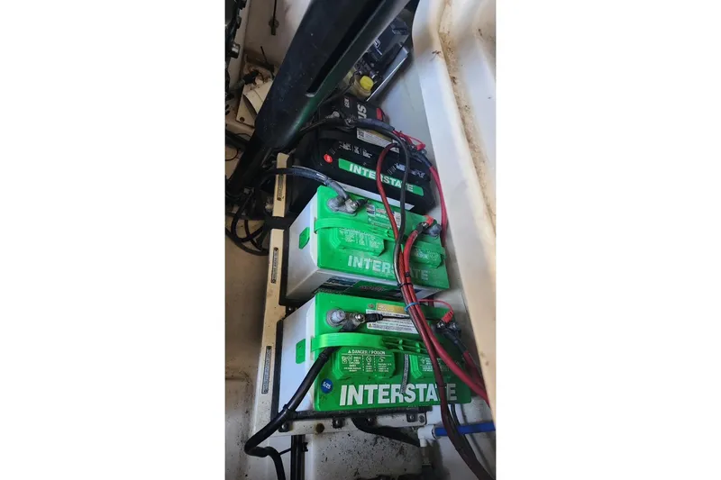 Slide: The Image of Batteries in a 2007 Four Winns 310 Horizon boat engine compartment. - 13