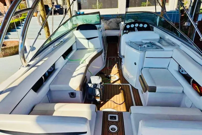 Slide: The Image of 2007 Four Winns 310 Horizon boat interior with white seating and wooden flooring. - 5