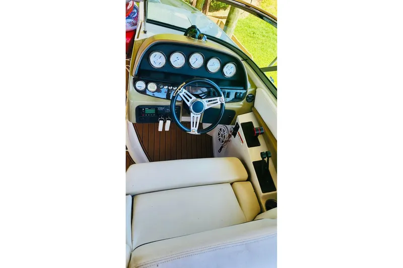 Slide: The Image of 2007 Four Winns 310 Horizon boat dashboard with steering wheel and gauges. - 8