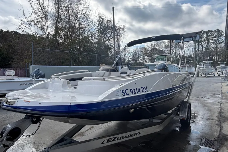 Slide: The Image of 2019 Starcraft MDX 191 O/B boat on trailer, parked outdoors. - 12