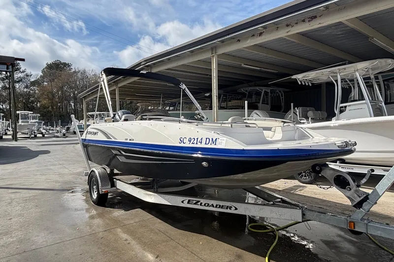 Slide: The Image of 2019 Starcraft MDX 191 O/B boat on trailer in marina setting. - 14