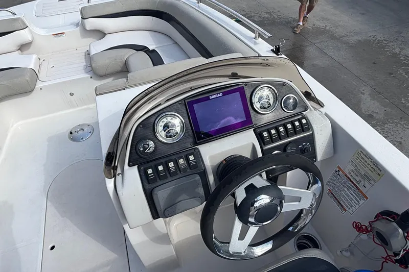 Slide: The Image of 2019 Starcraft MDX 191 O/B boat dashboard with steering wheel and control panel. - 18