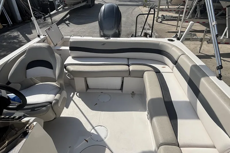 Slide: The Image of 2019 Starcraft MDX 191 O/B boat interior with seating and steering wheel. - 20