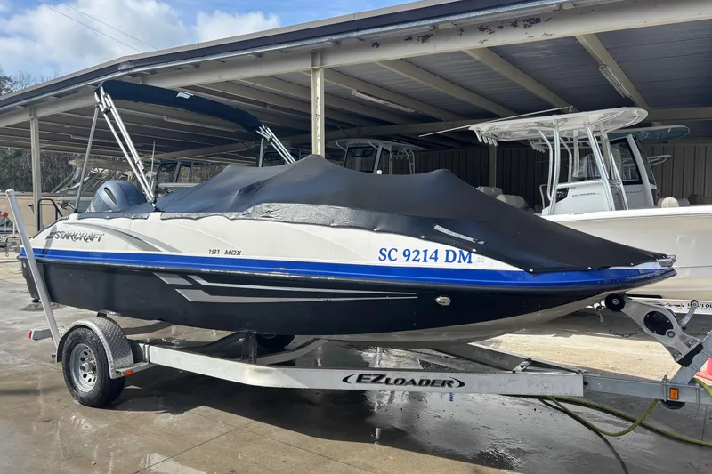 Slide: The Image of 2019 Starcraft MDX 191 O/B boat on trailer, covered and parked under shelter. - 23