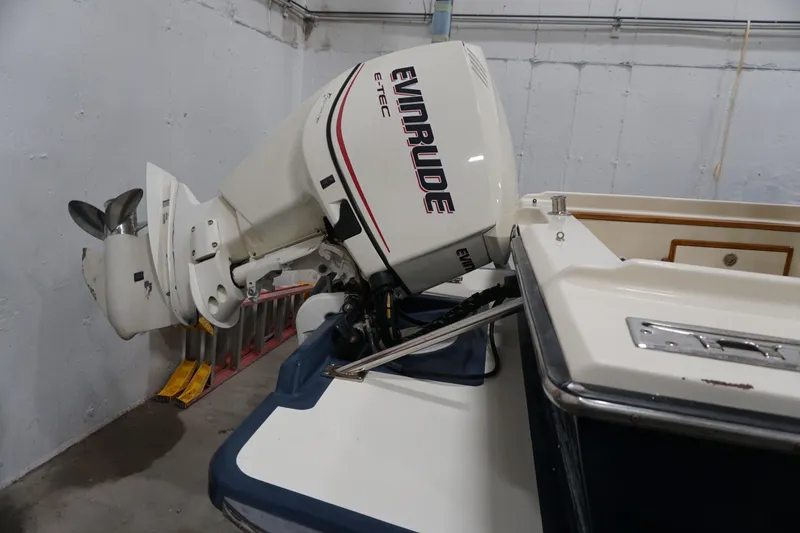 Slide: The Image of 2003 Padebco 23 boat with Evinrude E-TEC outboard motor in storage. - 10