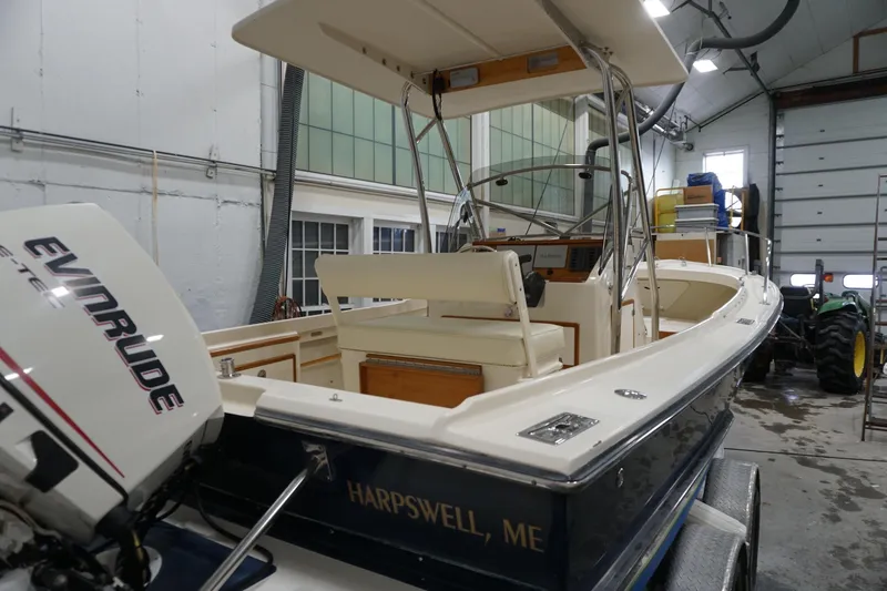 Slide: The Image of 2003 Padebco 23 boat in a garage, featuring Evinrude engine, Harpswell, ME. - 11