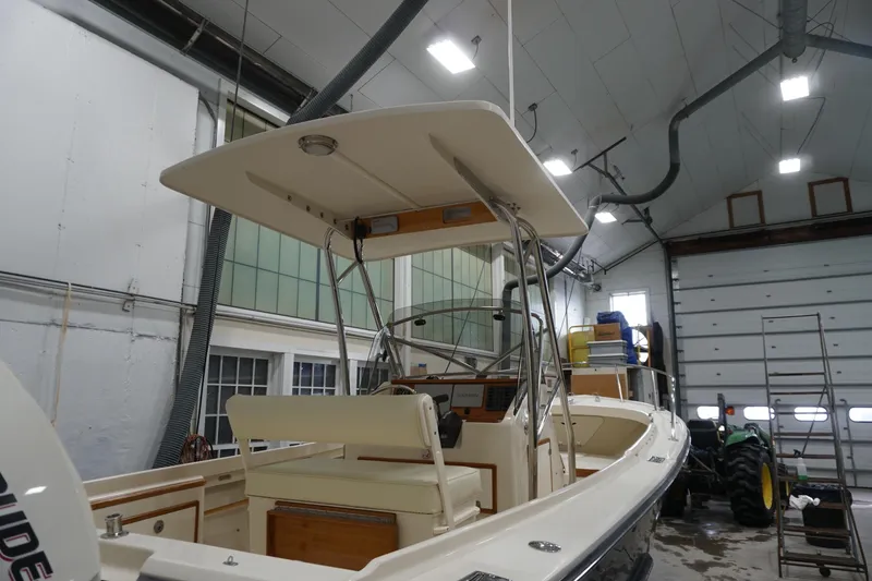 Slide: The Image of 2003 Padebco 23 boat in a garage, featuring a T-top and center console. - 12
